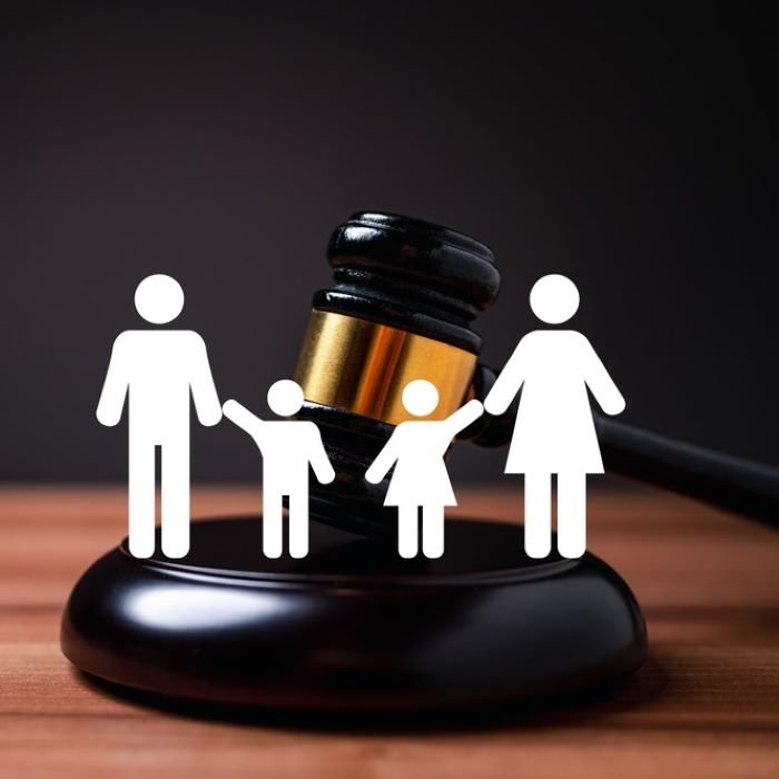 Judges gavel and cut out figures of family