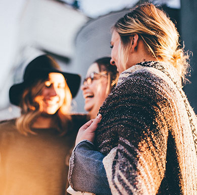 Three women talking and laughing